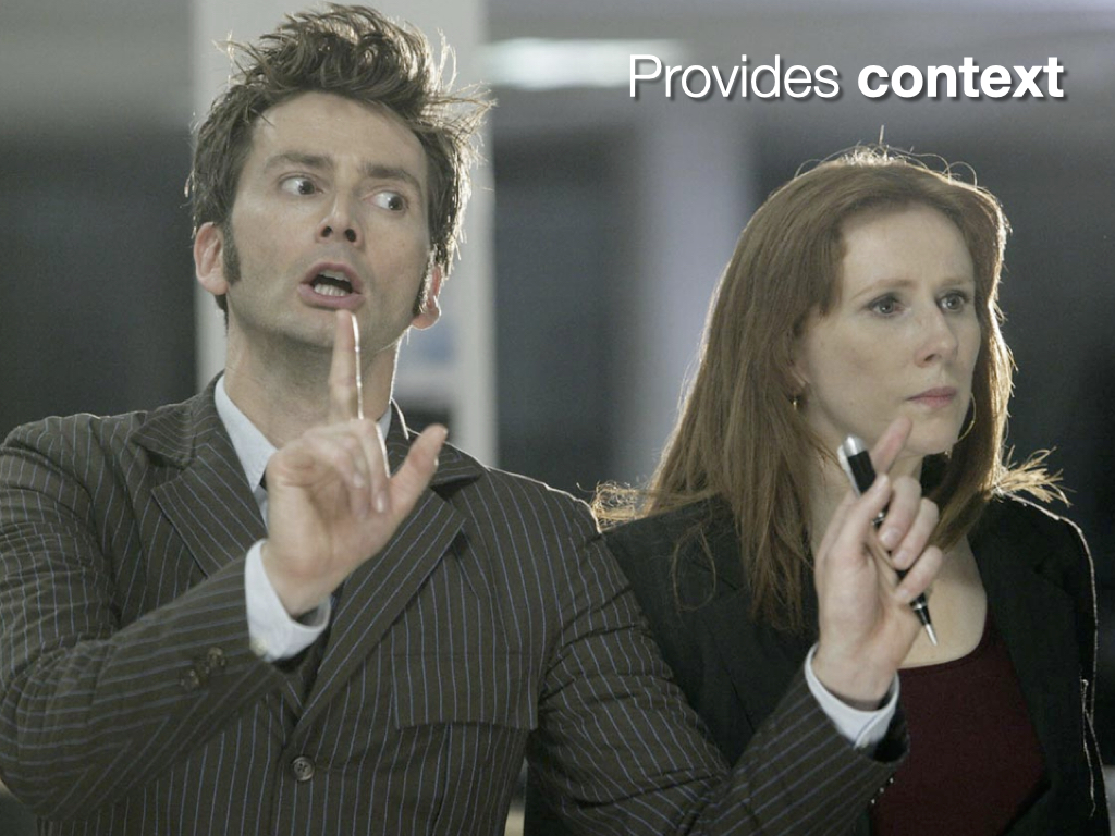 Provides context. The image is David Tennant as the Doctor and his companion Donna Noble from the BBC series Doctor Who.